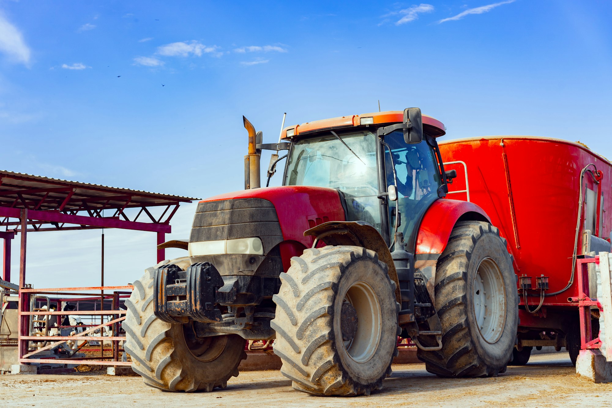 Modern red agricultural tractor in a farm